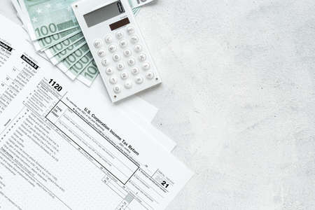 Tax form under US law with culculator on office table desktop