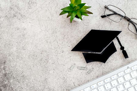 Graduation at the university concept. Academic cap on students tableの写真素材