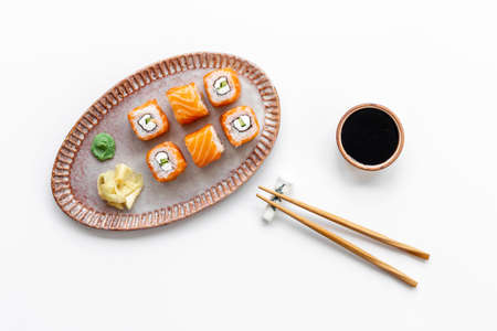 Salmon sushi rolls set on plate, top view. Japanese cuisine