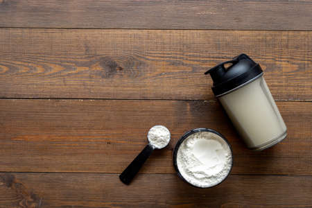 Food supplement for training - whey protein in jar and shakerの写真素材