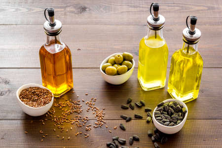 Bottles of vegetarian cooking oil - sunflower olive and sesame oil with seeds