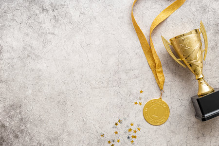 Winner concept with gold medal first place and award trophy cup
