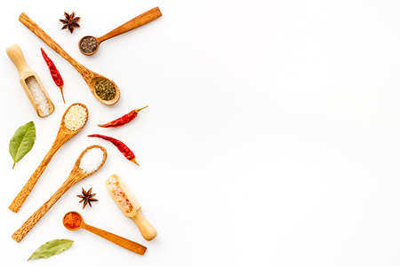 Cooking background with colorful spices and herbs in wooden spoons, top viewの写真素材