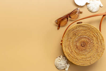Womans beach accessories - rattan bag with sunglasses and seashellsの写真素材