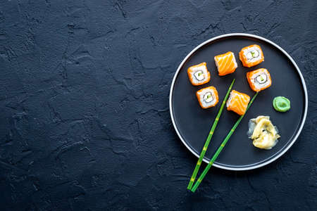 Japanese cuisine. Salmon sushi rolls set on plate, top viewの写真素材