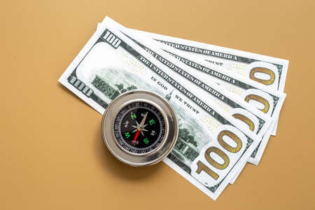Exchange rate change concept with compass and money cashの写真素材