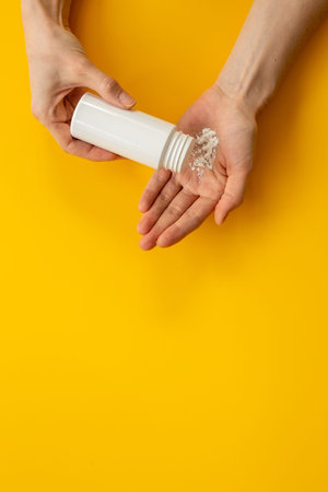 Woman applying baby talcum powder on hand. Skin care cosmetic