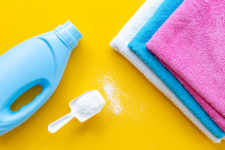 White washing powder with towels and a laundry conditioner bottleの写真素材