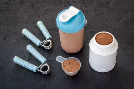 Sports nutrition background. Whey protein in jar and shaker bottleの写真素材