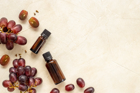 Grape seed oil in bottles with bunch of grapes. Eco cosmetic productの写真素材