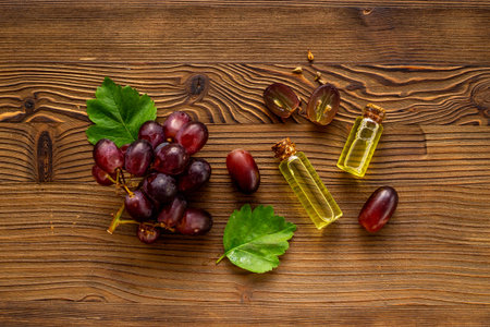 Grape seed essential oil with bunch of grapes. Eco cosmetic productの写真素材