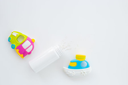 Baby care cosmetic - talcum powder in container with kids toys