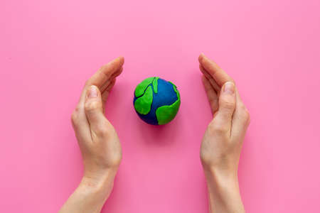 Handmade clay world in hands. Eco and Earth Day conceptの写真素材