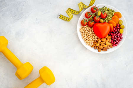 Healthy lifestyle and nutrition eating concept. Food with sports fitness equipmentの写真素材