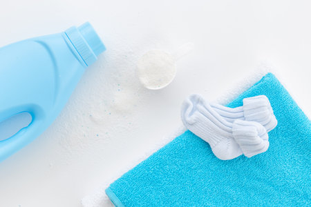 White washing powder with towels and a laundry conditioner bottleの写真素材