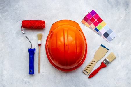 House renovation and painting background with construction helmet and brushesの写真素材