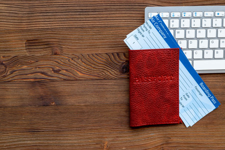 Booking tickets online - passport with air tickets on keyboard