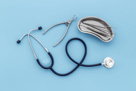 Dental or surgical steel instruments with stethoscope. Healthcare background