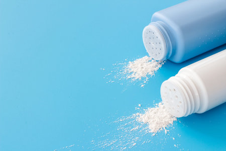 Spilled baby talcum powder in container. Kids skin care cosmeticの写真素材