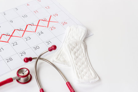 Stethoscope and calendar with red days of menstruation period. Women health