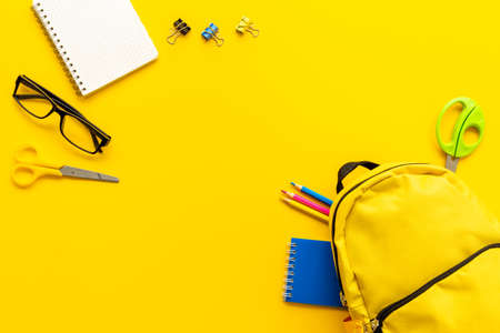 Students supplies in yellow school backpack. Back to school conceptの写真素材