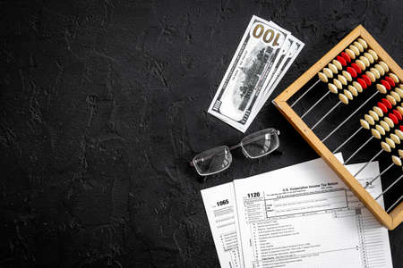 Business tax calculations with accounting wooden abacusの写真素材