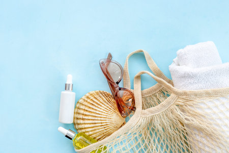 Womans beach accessories - grid string bag with sunglasses and towel
