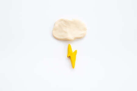 Plasticine clouds with lightning thunderbolt. Weather forecast conceptの写真素材