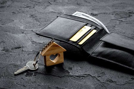 House shaped key chain and keys with wallet. Sale or rent real estateの写真素材