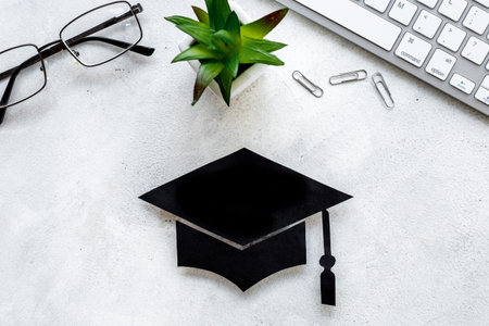 Academic cap or graduation hat on students desk. Education conceptの写真素材