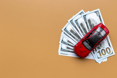 Saving money to buy a car. Toy car with money cash