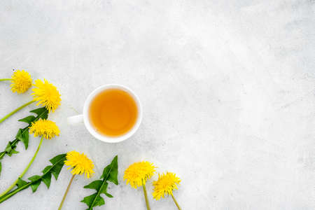 Herbal tea with meadow healing herbs - yellow dandelions blossoms and leavesの写真素材
