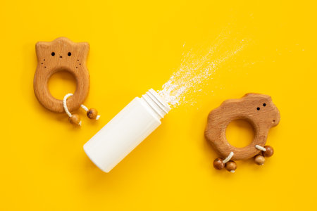 Talcum powder in container with kids toys. Baby care cosmeticの写真素材