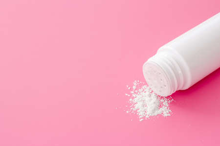 Spilled baby talcum powder in container. Kids skin care cosmeticの写真素材