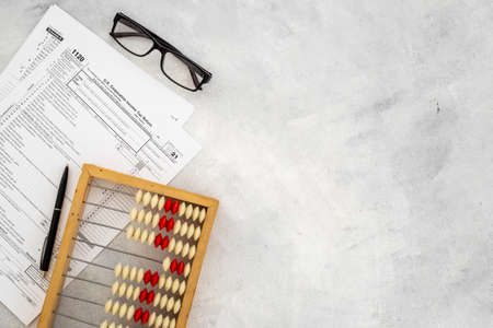 Business tax calculations with accounting wooden abacusの写真素材