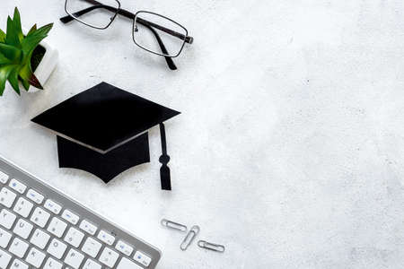 Academic cap or graduation hat on students desk. Education conceptの写真素材