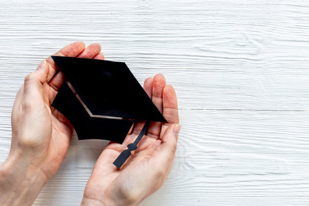 Students hands with graduation hat or academic cap paper cutの写真素材