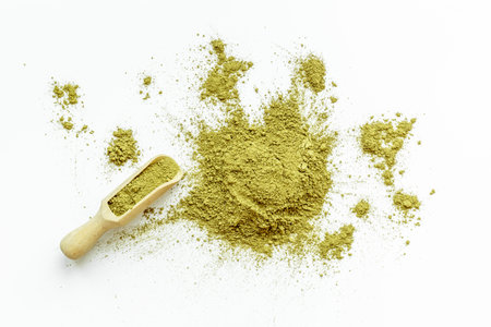 Isolated splash of matcha tea powder on white backgroundの写真素材