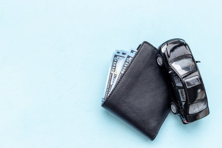 Purchase or rent a car concept. Toy car with wallet and money cashの写真素材