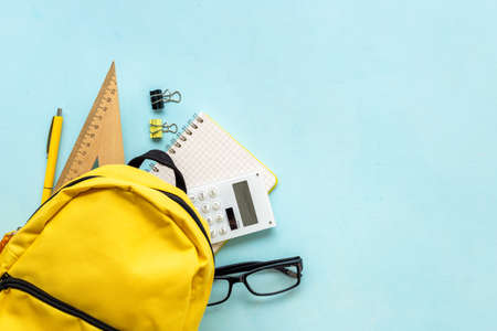 Yellow school backpack with student accessories. College and school conceptの写真素材