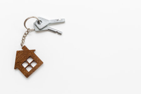 Sale or rent real estate concept. house shaped keychain and keysの写真素材