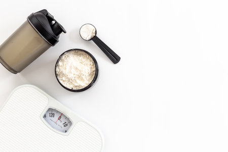 Sport diet food - whey protein in jar and scales. Fitness and gym conceptの写真素材