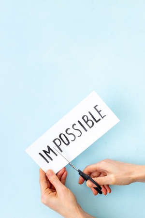 Paper card Impossible change into Possible with scissorsの写真素材
