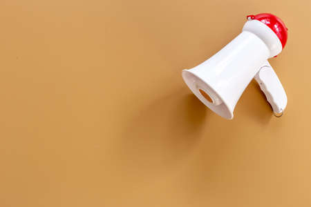 White megaphone against the empty wall. Hiring or advertising conceptの写真素材