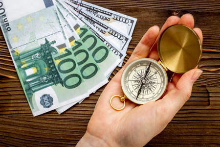 Compass in businessmans hand. Business navigates recovery conceptの写真素材