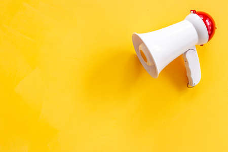 White megaphone against the empty wall. Hiring or advertising conceptの写真素材