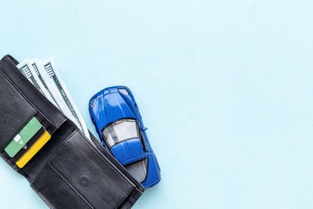 Toy car with wallet and money. Purchase a car conceptの写真素材
