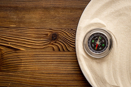 Compass in the sand. Business navigates recovery conceptの写真素材