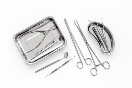 Dental or surgical instruments in steel tray at doctor desk