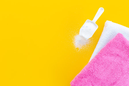 Laundry detergents powder with scoop and fresh towelsの写真素材